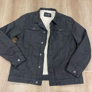 Indigo Star black men's trucker jacket with a sherpa lining.